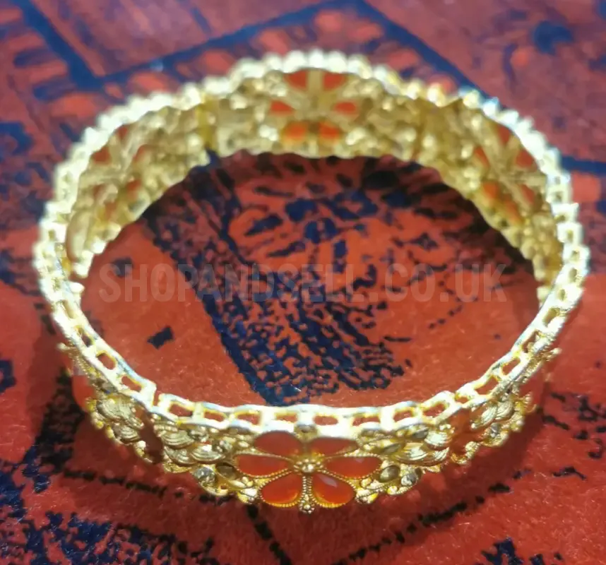 Gold-Tone Ornate Bangle Bracelet with Red Floral Design